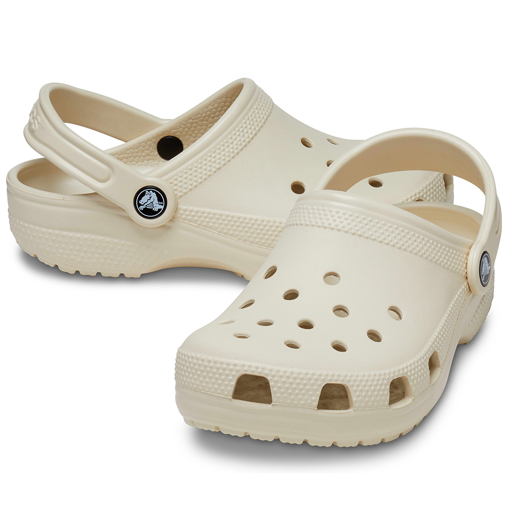 Pair of Kids Crocs in bone colour with strap at the back both in "sports mode"