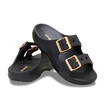 Pair of black Crocs womens slip-on sandals with metallic buckles