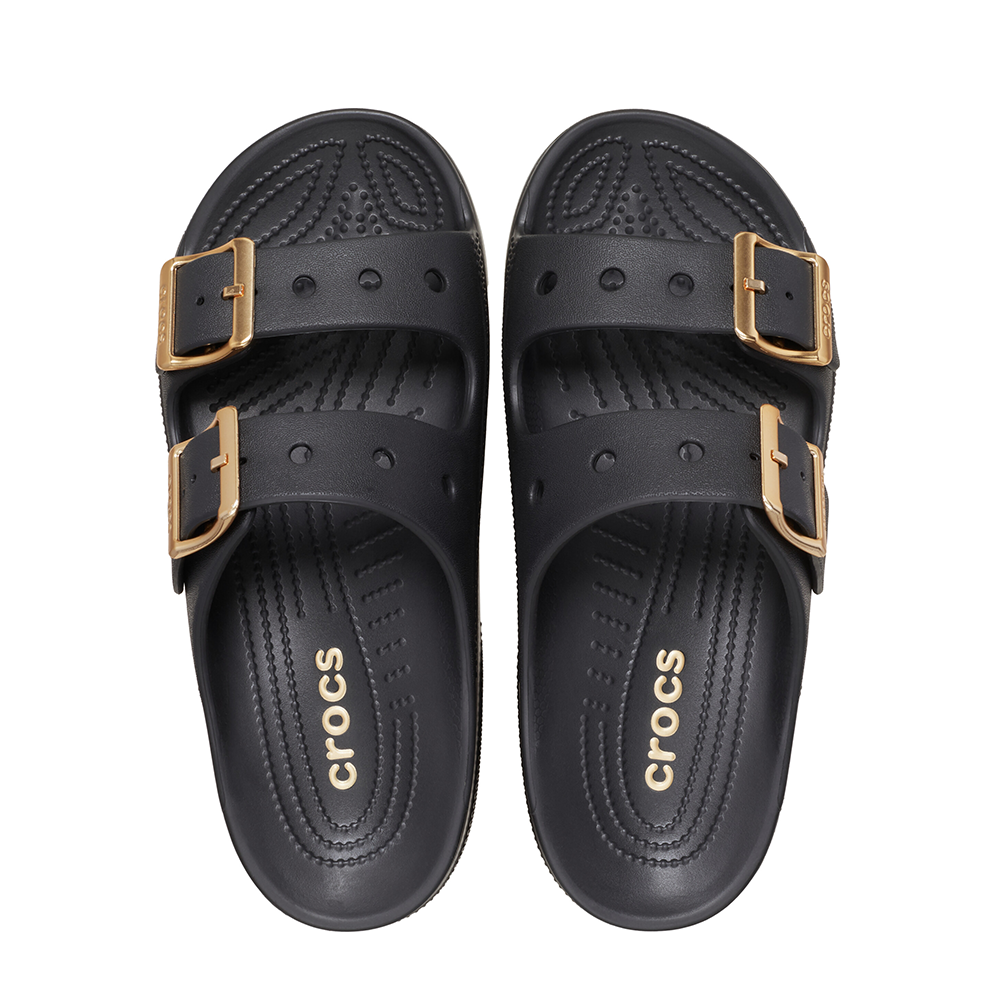 A pair of black Crocs double-strap slide sandals with gold-tone buckle details, shown from a top-down view on a white background.