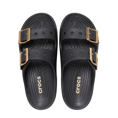 A pair of black Crocs double-strap slide sandals with gold-tone buckle details, shown from a top-down view on a white background.