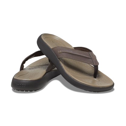 A pair of two tone brown Crocs flip-flops